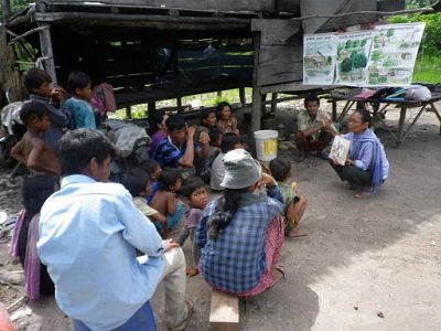 Families gather for a Health Education training session with HOPE Cambodia staff, Nari. Families learn to use water to improve personal hygiene and sanitary household practices.